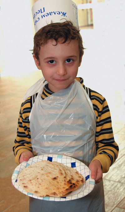 В руках у мальчика маца - единственный вид хлеба, употребляемый в праздник Песах